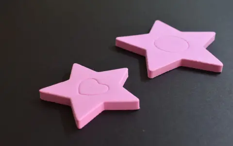 Dos estrellas rosas de goma eva, una con un corazón, demuestran que la goma eva se puede mojar sin dañarse.